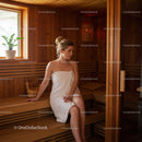 Relaxing Woman Sitting in Wooden Sauna with Towel