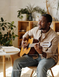 Man enjoying acoustic guitar in cozy home setting