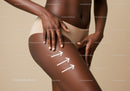 Dark-Skinned Woman Touching Thigh with Arrows on Skin in Studio