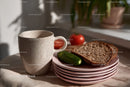 Coffee Mug with Whole Grain Bread Cucumber and Tomato on Table