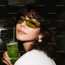Fashionable Woman Wearing Yellow Sunglasses with Green Cocktail
