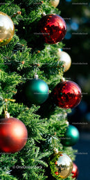 Festive Christmas tree decorated with colorful shiny baubles