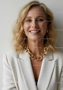 Confident Woman Wearing Gold Jewelry Smiling Indoor Portrait