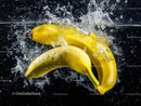 Fresh Bananas Splashing into Water in Vibrant Summer Scene