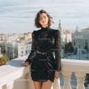 Stylish Woman Wearing Black Dress on City Balcony with Skyline View