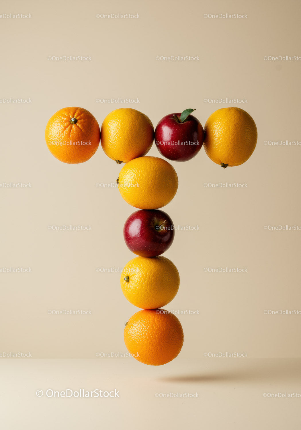 Creative T Shape Formed by Floating Citrus and Apples