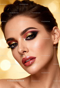 Close-up of woman with glamorous gold and red makeup