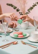 Elegant Pink and Green Macarons on Stylish Table with Fine China
