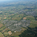 Aerial View of Suburban City with Green Fields and Urban Infrastructure