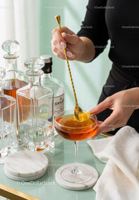 Elegant Cocktail in Martini Glass with Lemon Twist and Bar Tools