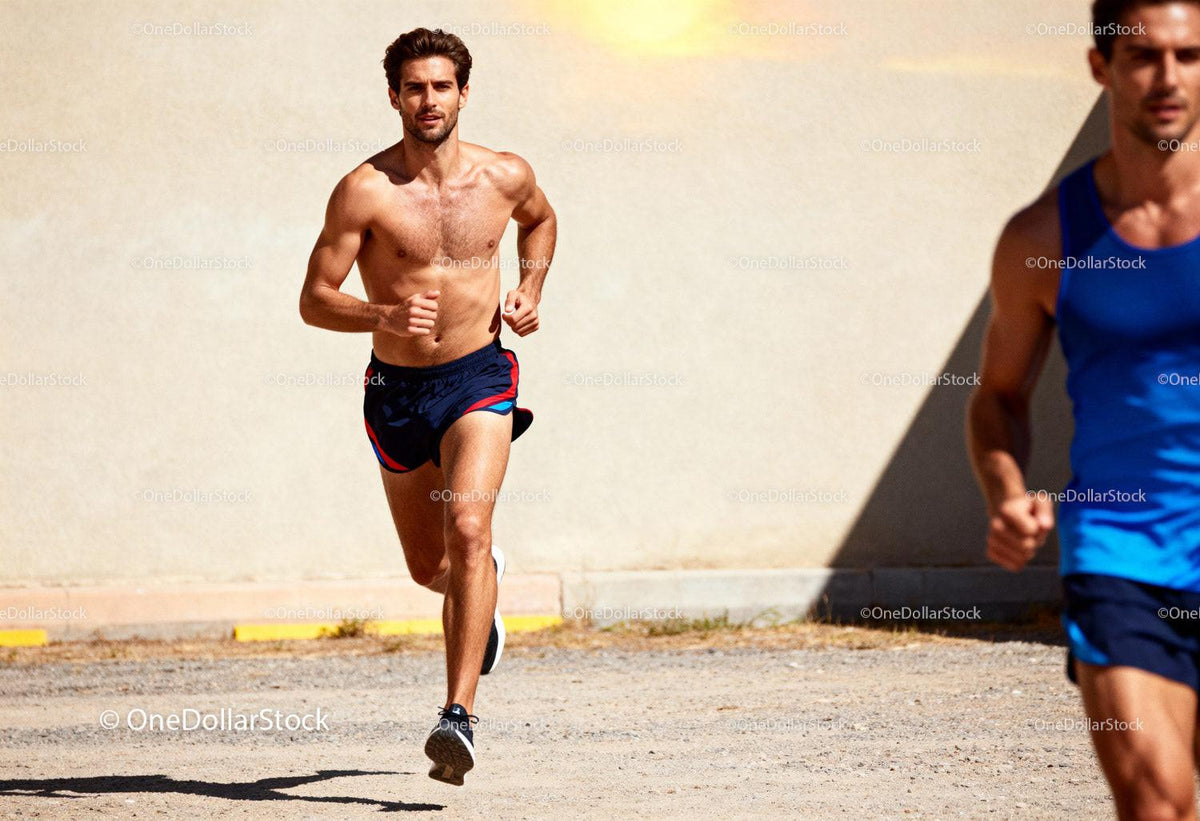 Two men running outdoors on sunny day in sportswear
