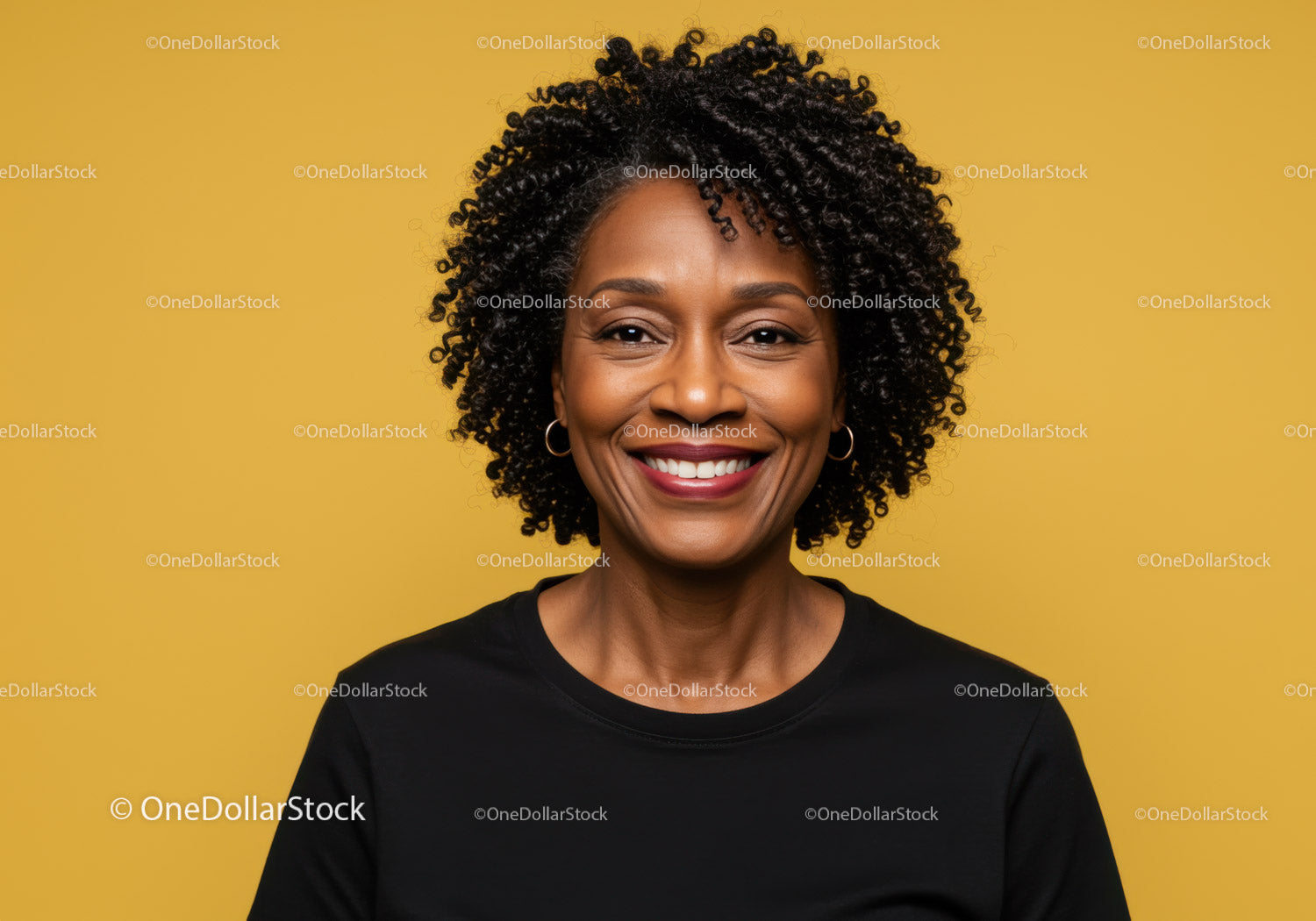 Confident Woman with Curly Hair Smiling in Studio Portrait