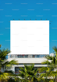Empty white billboard above tropical palm trees