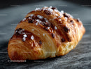 Fresh Chocolate Chip Croissant with Sugar Topping on Wooden Surface