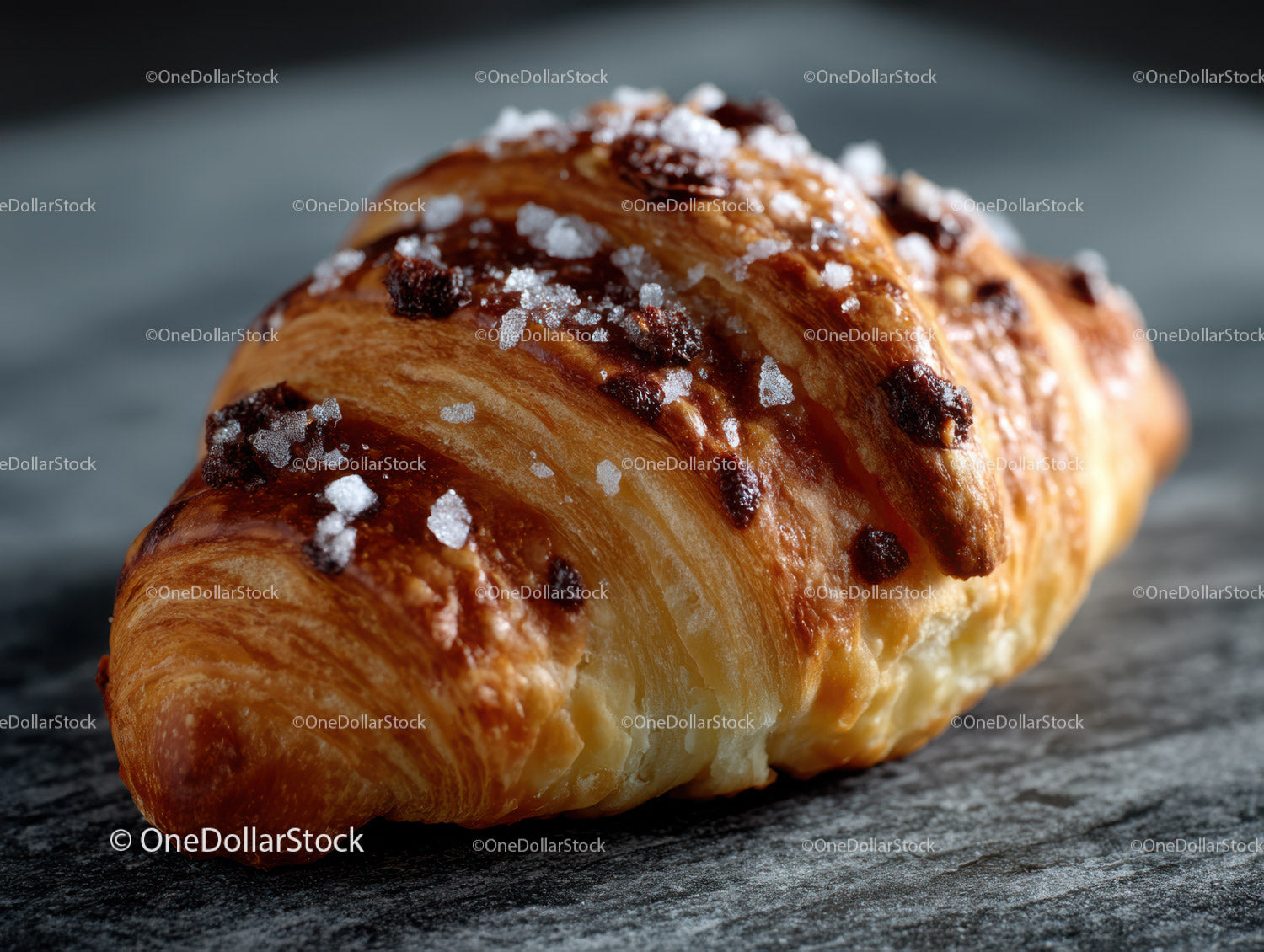 Fresh Chocolate Chip Croissant with Sugar Topping on Wooden Surface