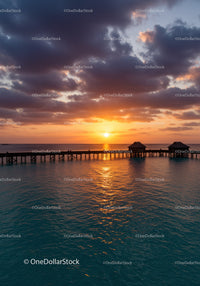 Scenic Sunset Over Ocean Pier with Dramatic Sky and Clouds
