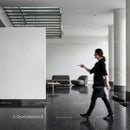 Woman Walking in Modern Minimalist Lobby Space