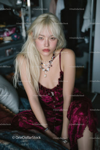 Elegant Woman in Velvet Dress with Jewelry in Indoor Portrait