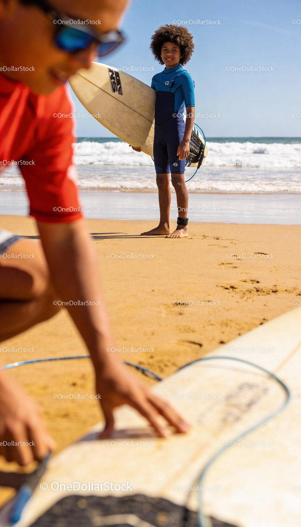 Young boy with surfboard ready to catch ocean waves
