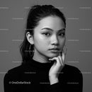 Elegant Black and White Portrait of Woman with Hoop Earrings and Thoughtful Expression