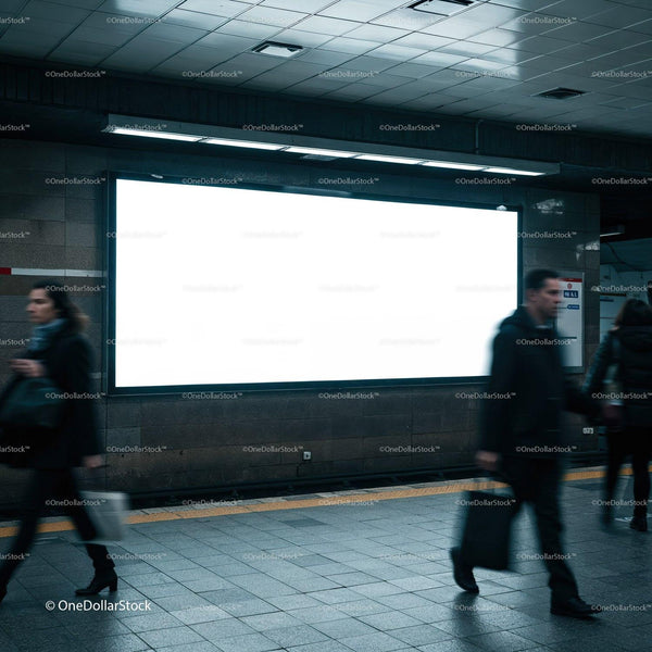 Busy commuters passing empty billboard in subway station JPG Mockup Image