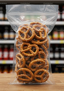Bag of salted pretzels on wooden counter in store