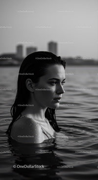 Serene Woman in Water with City Skyline in Black and White