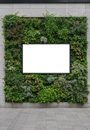 Blank White Billboard Framed by Vertical Garden on Wall
