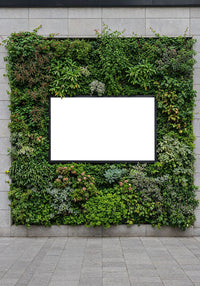 Blank White Billboard Framed by Vertical Garden on Wall