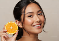 Beautiful Woman Smiling with Fresh Orange Slice on Her Face