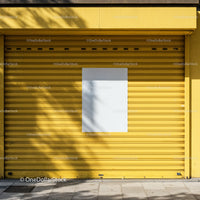 Closed yellow shutter with blank white poster outdoors