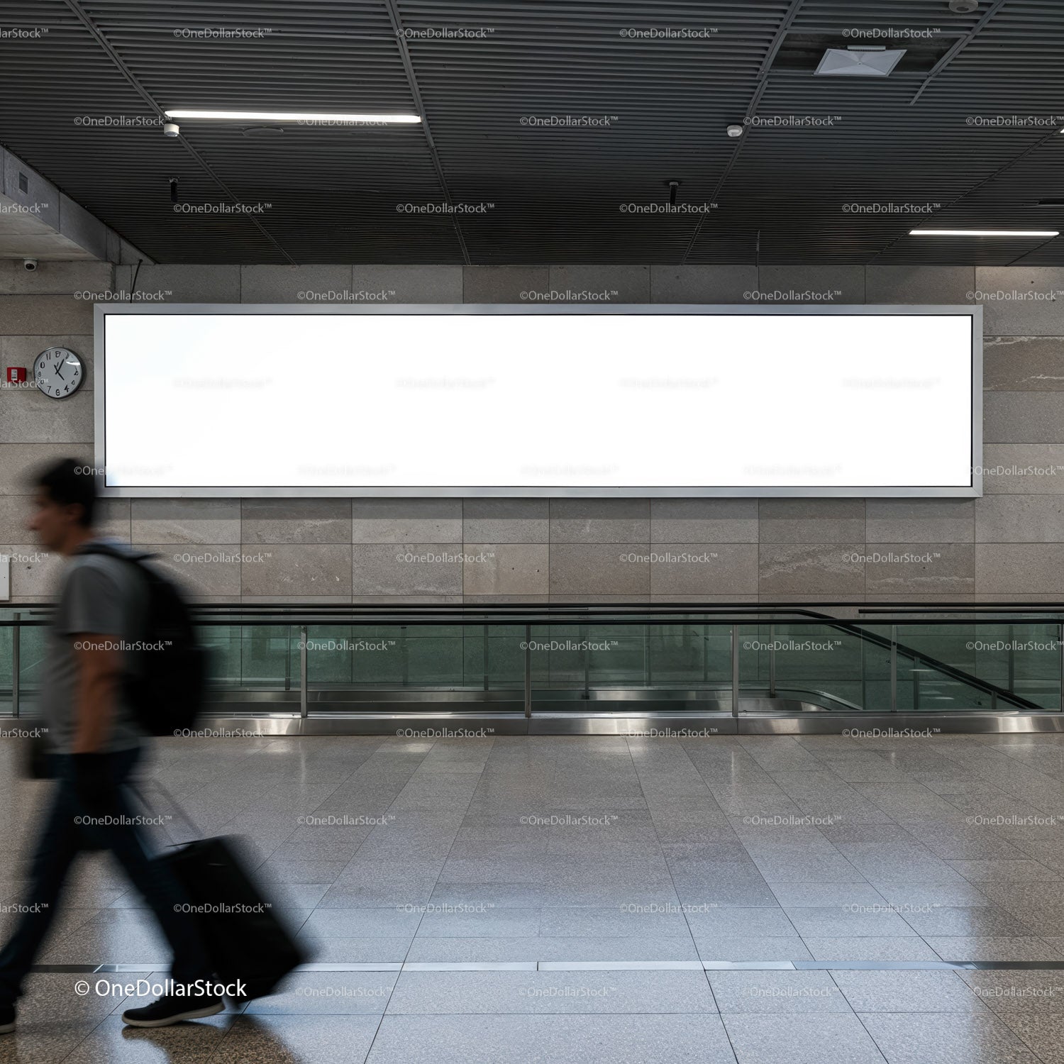 Traveler walking past blank billboard in modern airport terminal