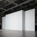Empty white exhibition walls with industrial ceiling lights