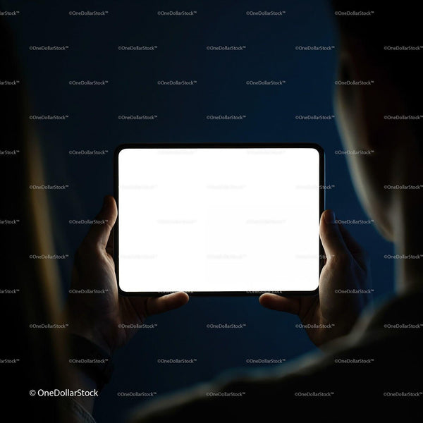 Person Holding Bright Tablet Screen in Dark Room JPG Mockup Image