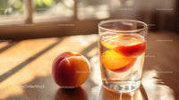 Fresh Peach Infused Water in a Clear Glass On Wooden Surface