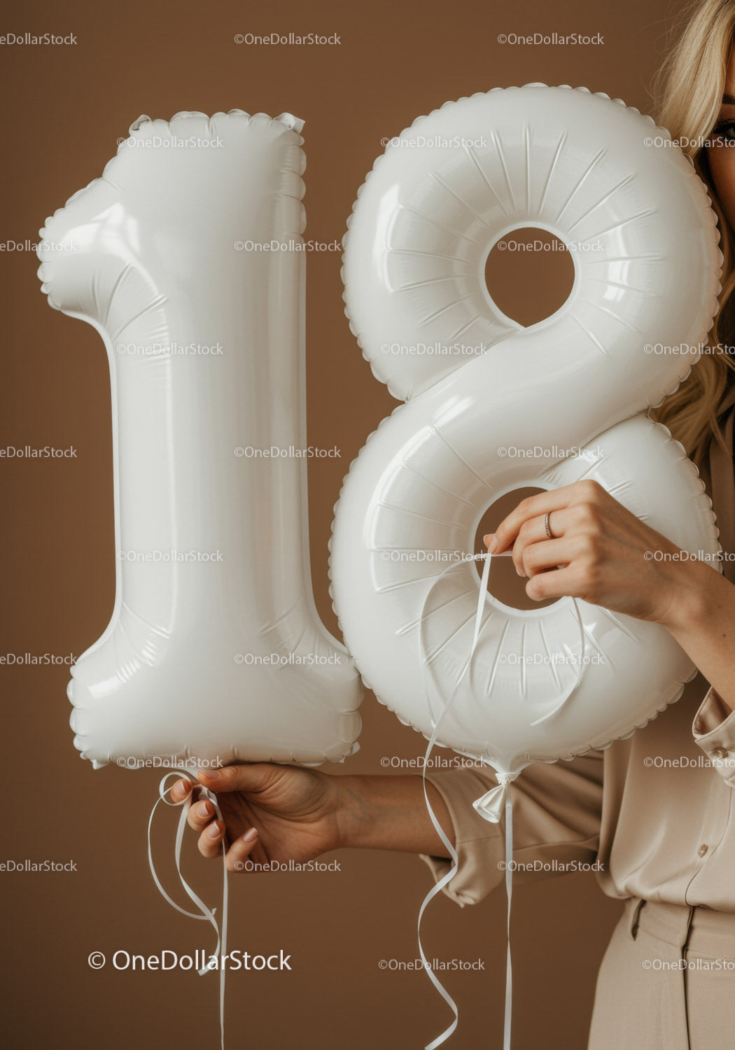 White Number 18 Balloon Held by Woman in Neutral Outfit