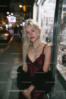 Stylish Young Woman in Red Velvet Dress with Jewelry in Night City