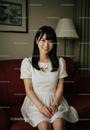 Smiling Young Woman Sitting on Sofa in Cozy Modern Living Room