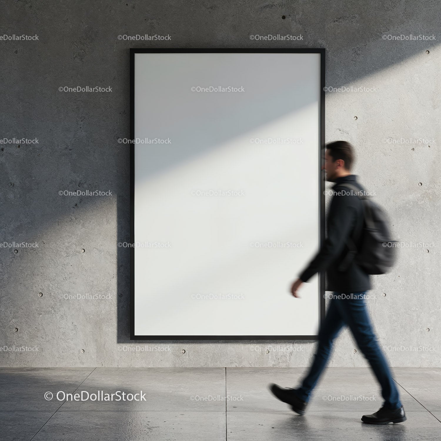 Man walking past blank poster on concrete wall