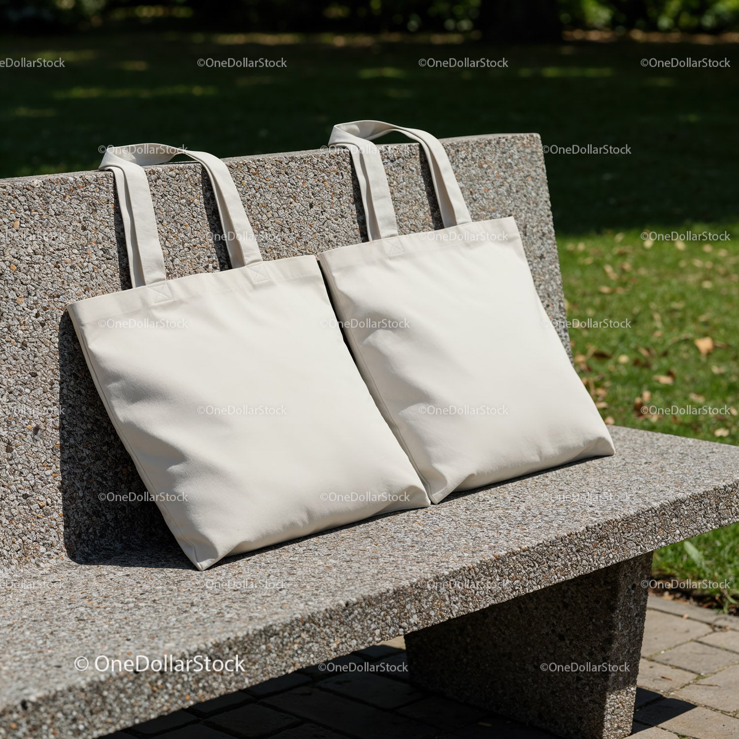 Two Plain Reusable Tote Bags on Outdoor Stone Bench
