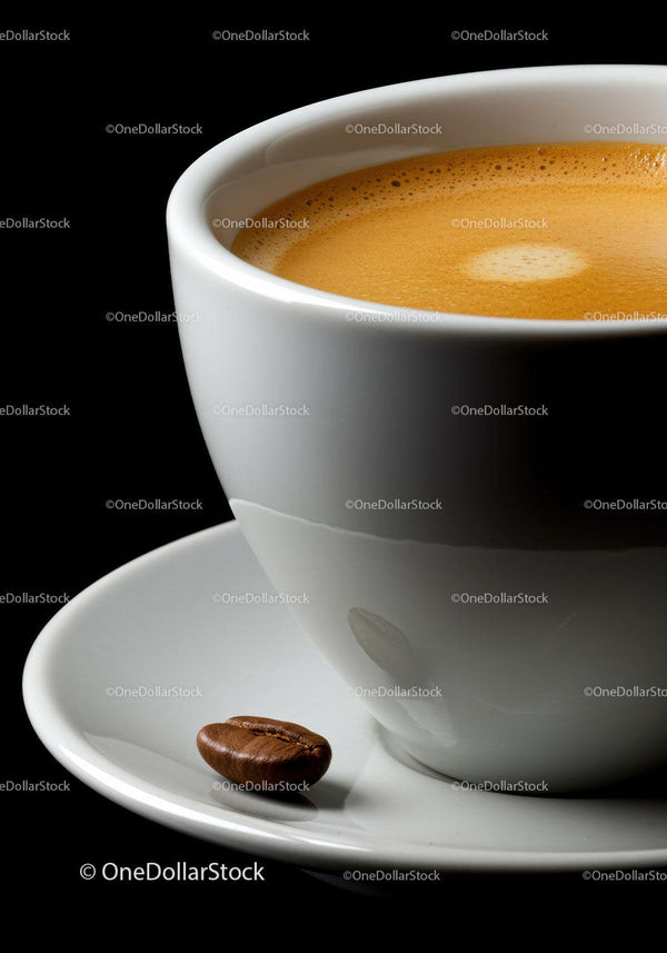 Close up of espresso cup with single coffee bean on saucer