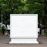 Blank white billboard in green urban park pathway