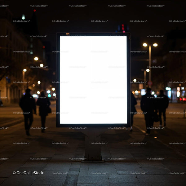 Illuminated blank billboard on urban street at night JPG Mockup Image