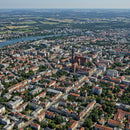 Cityscape of a Historic Town with Red Roofs and River View