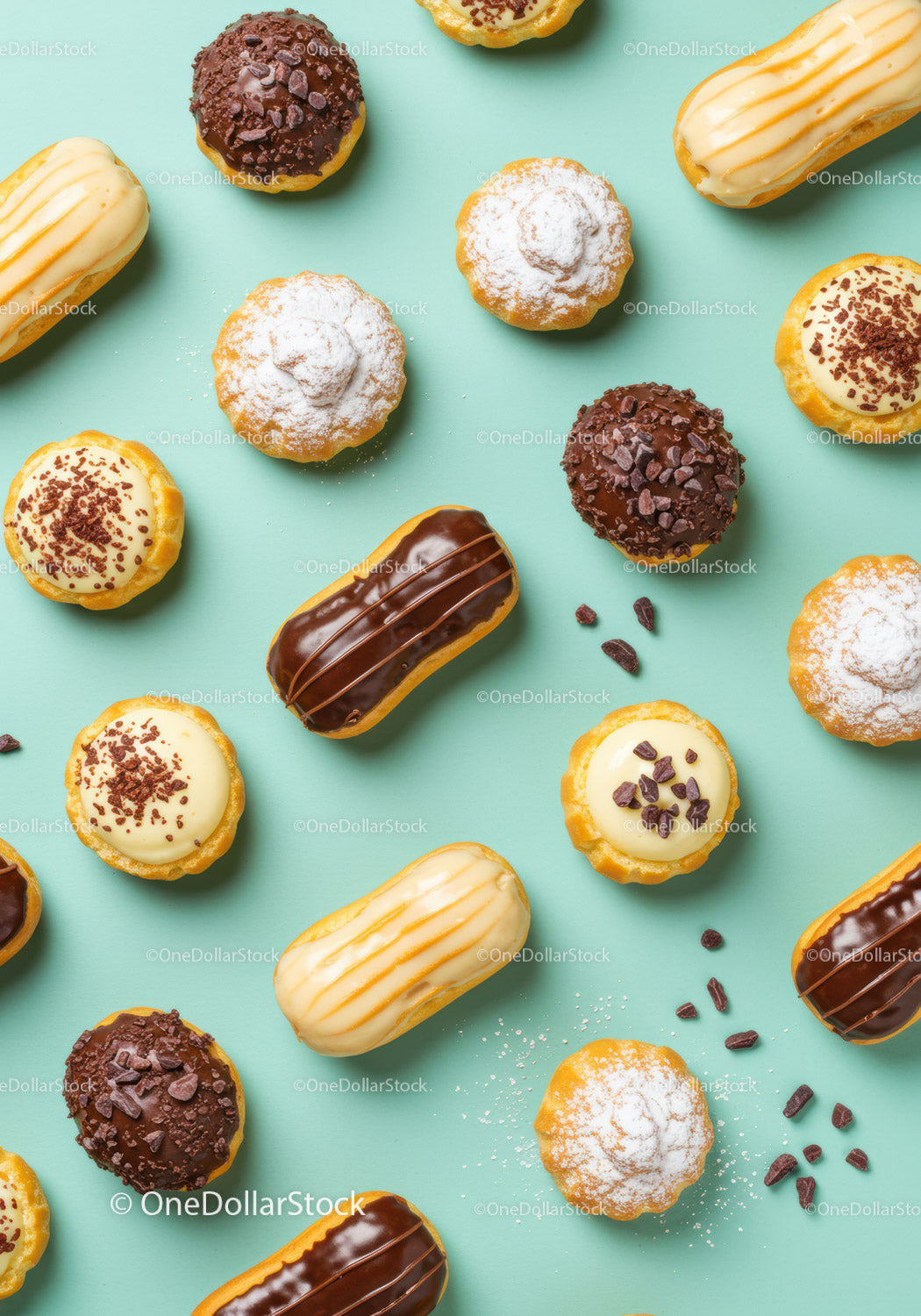 Variety of Mini Eclairs and Cream Tarts on Blue Background