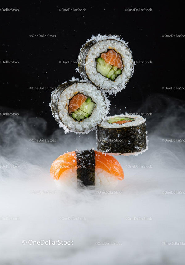 Fresh salmon sushi and maki rolls with smoky background
