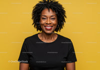 Confident Smiling Woman with Curly Hair in Black T-Shirt on Yellow Background