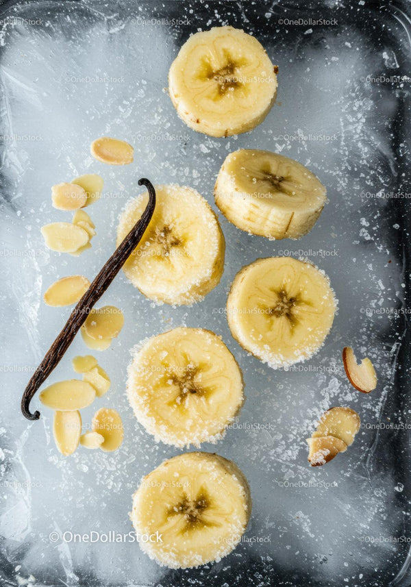 Frozen banana slices with vanilla and almond flakes on ice