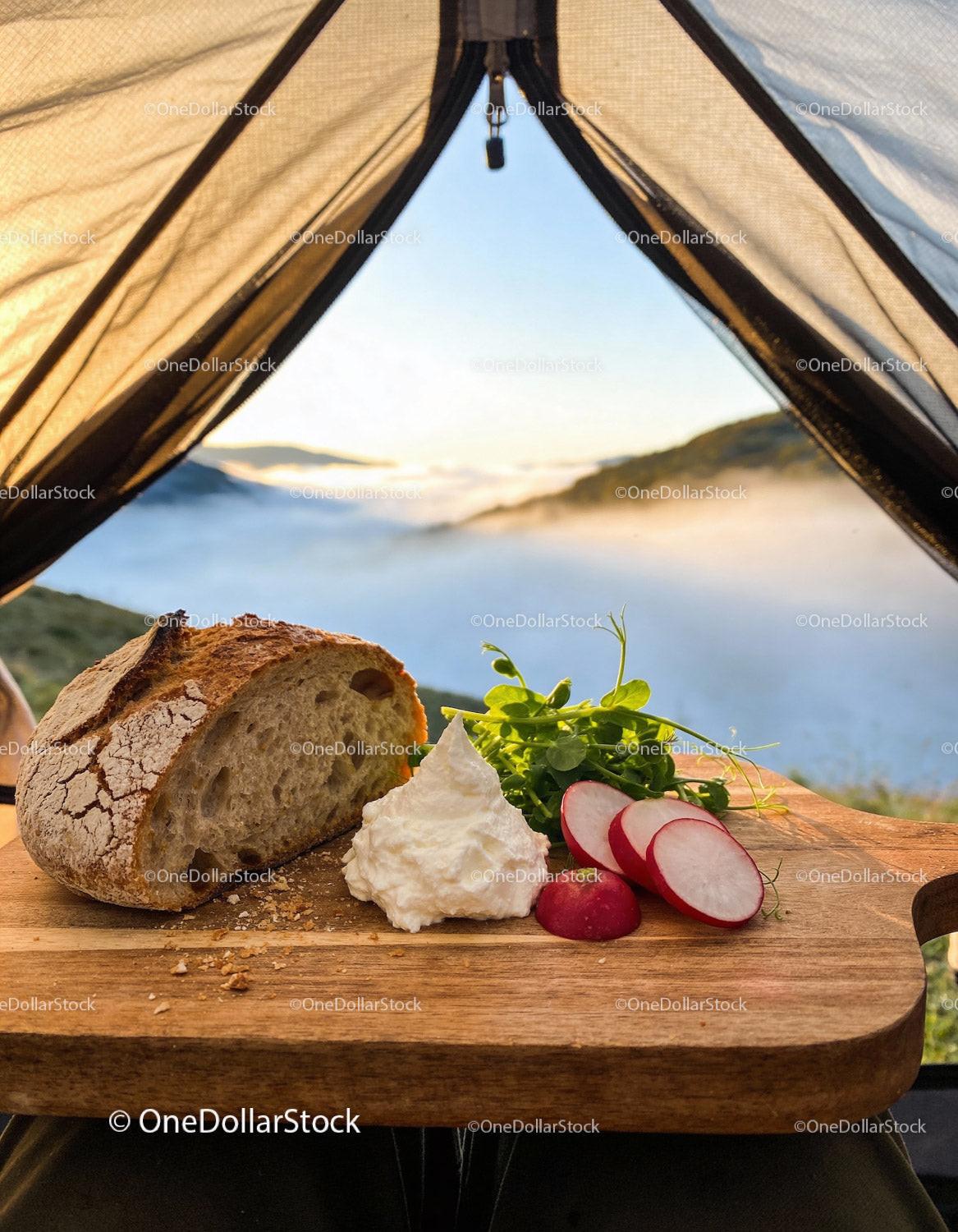 Rustic breakfast with fresh bread and radishes at campsite
