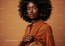 Elegant African Woman in Orange Satin Blouse with Gold Accessories